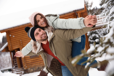 Lovely couple spending time together on snowy day. Winter vacation