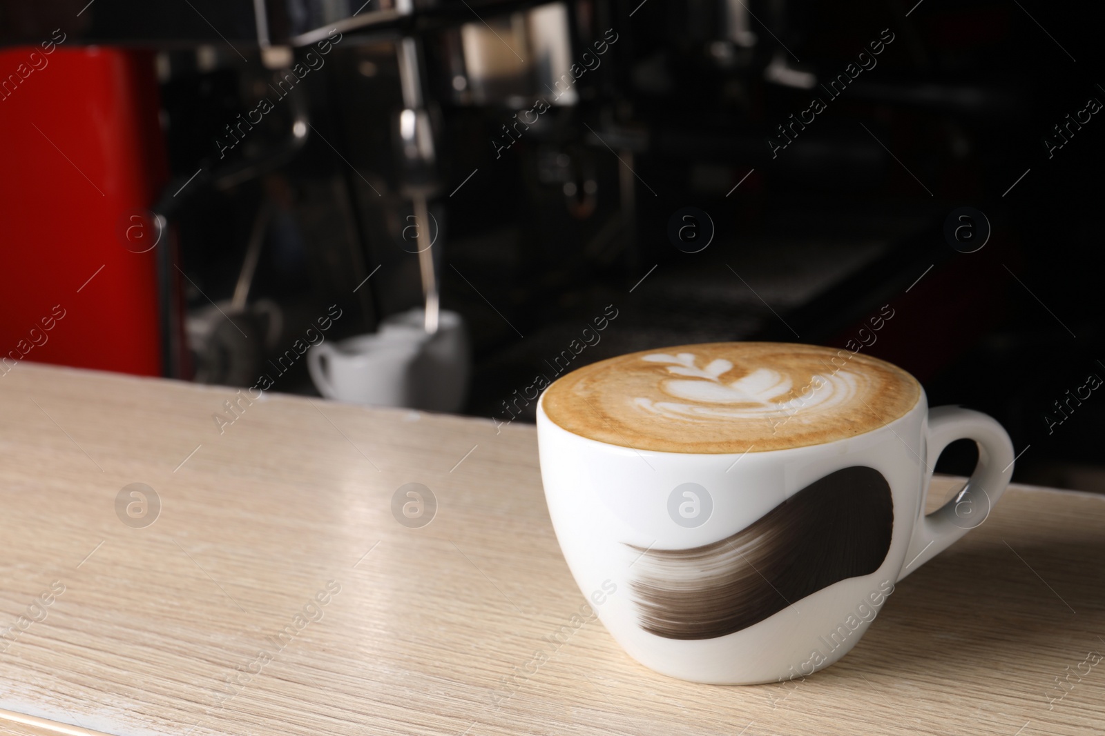 Photo of Cup of fresh aromatic coffee on wooden counter in cafe, space for text