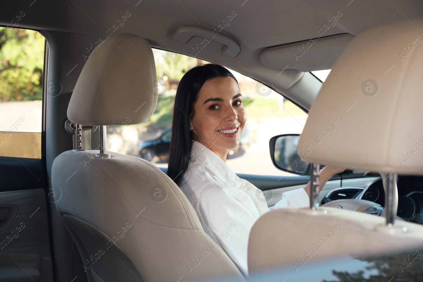 Photo of Beautiful young driver sitting in modern car