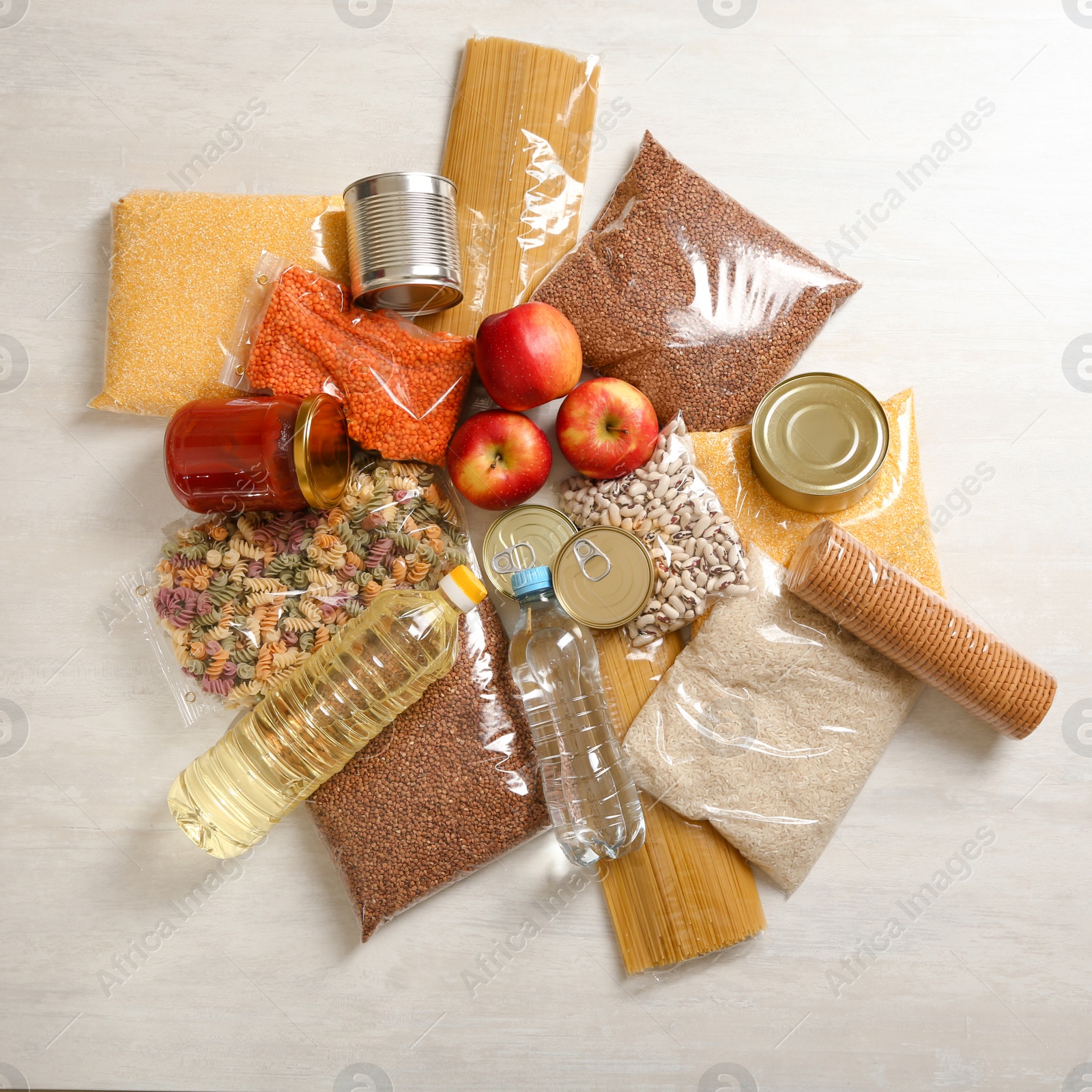 Photo of Many different products on white wooden background, flat lay. Food donation