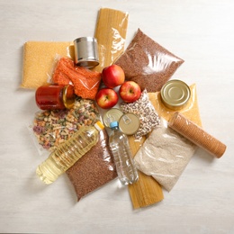 Photo of Many different products on white wooden background, flat lay. Food donation