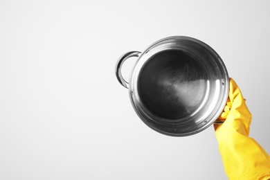 Photo of Woman holding empty pot on white background, closeup. Space for text