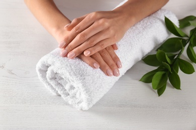 Closeup view of woman with beautiful hands at table. Spa treatment