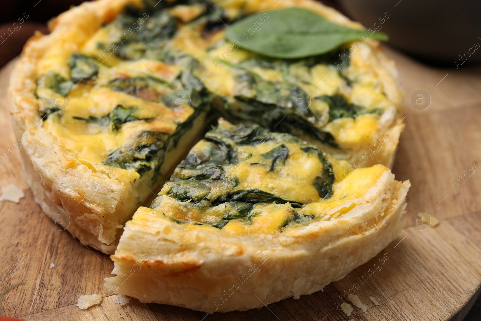 Photo of Delicious pie with spinach on table, closeup