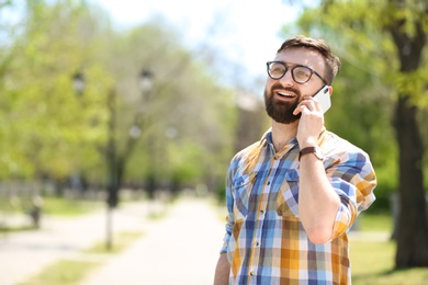 Photo of Portrait of young man talking on phone outdoors