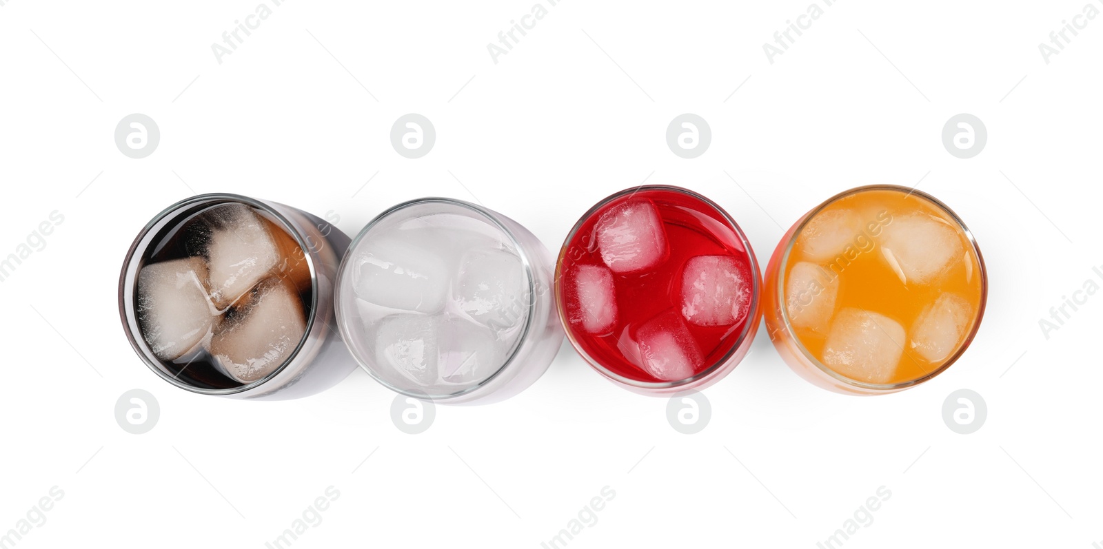 Photo of Glasses of different refreshing soda water with ice cubes on white background, top view