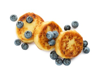 Delicious cottage cheese pancakes with fresh blueberries on white background, top view