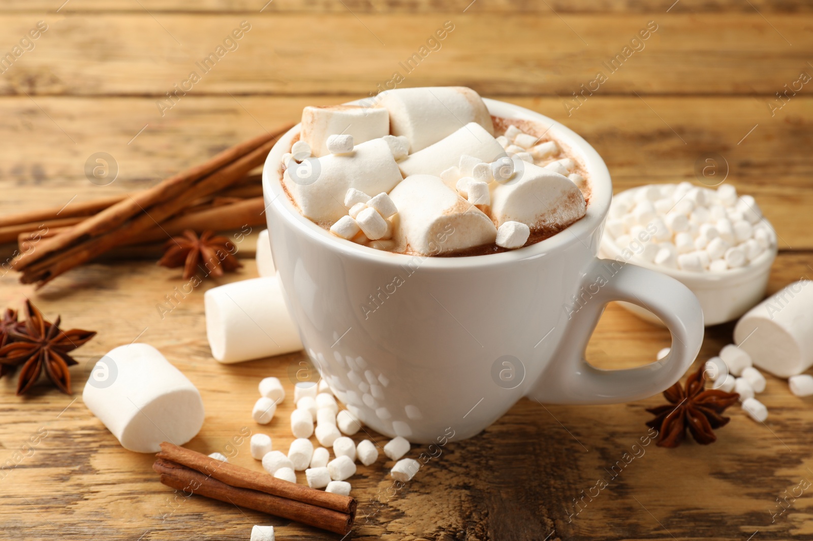 Photo of Tasty hot chocolate with marshmallows on wooden table, closeup