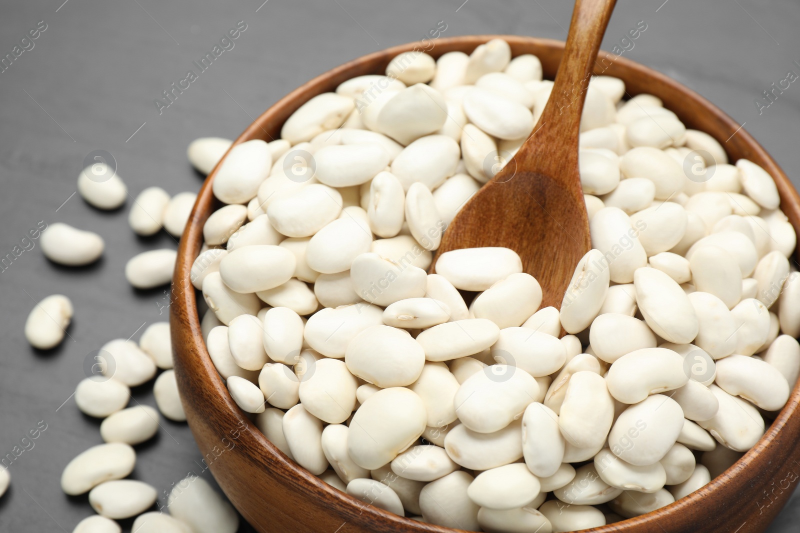 Photo of Raw white beans on grey table, closeup