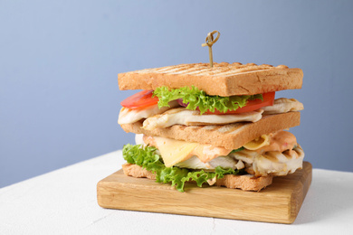 Photo of Tasty sandwich with chicken on white table