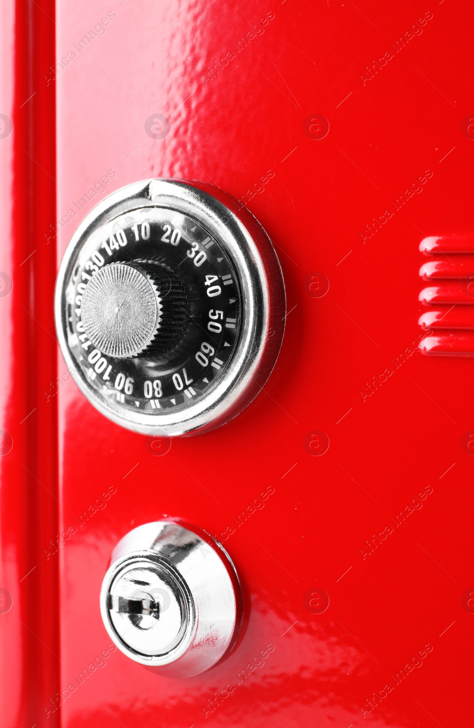 Photo of Red steel safe with mechanical combination lock, closeup