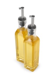 Photo of Glass bottles of cooking oil on white background