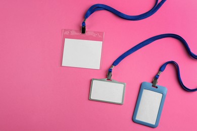 Blank badges on pink background, flat lay. Mockup for design