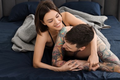 Photo of Passionate couple having sex on bed at home