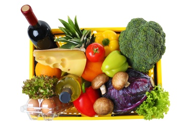 Photo of Shopping basket with grocery products on white background, top view