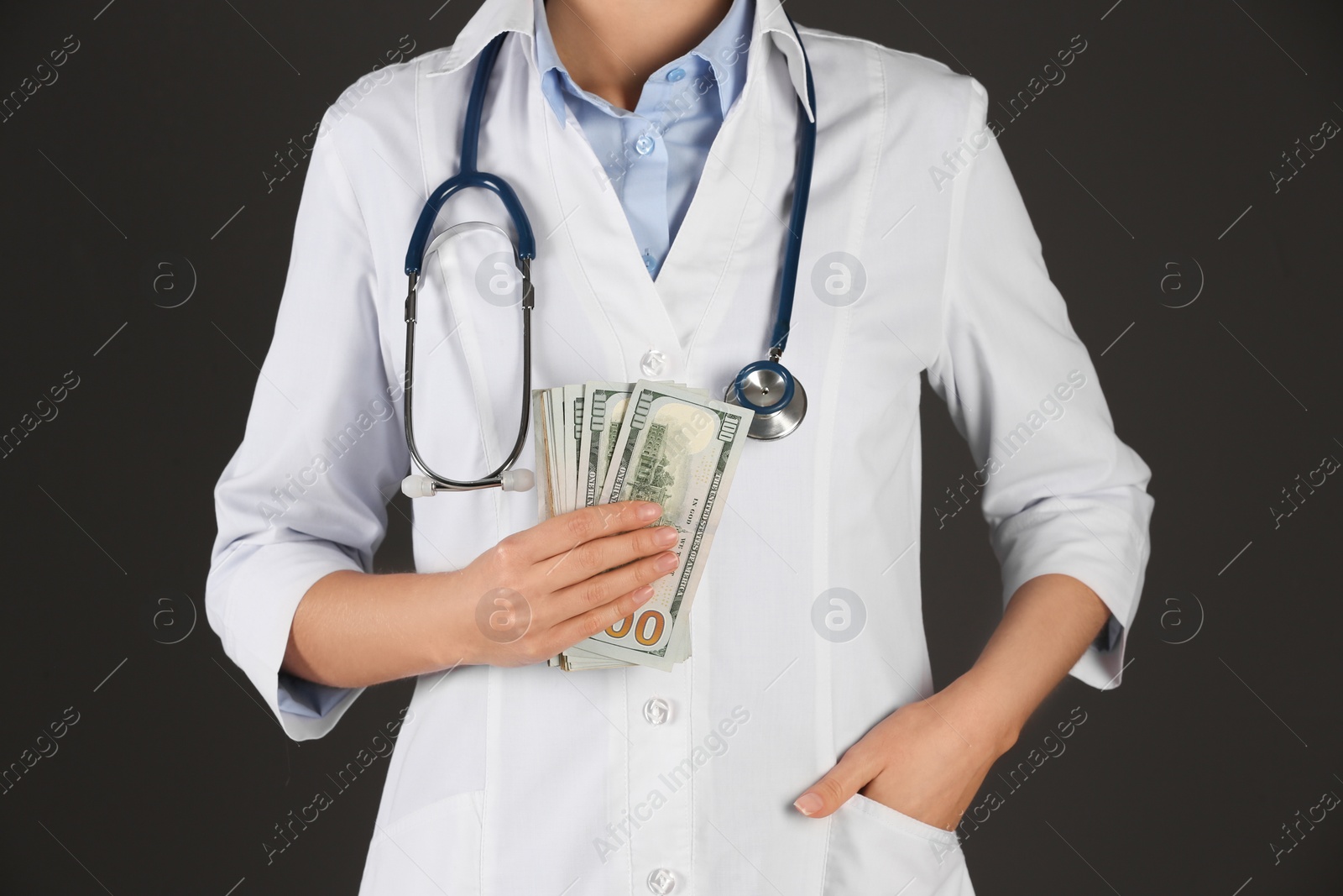 Photo of Doctor with bribe on black background, closeup. Corruption in medicine