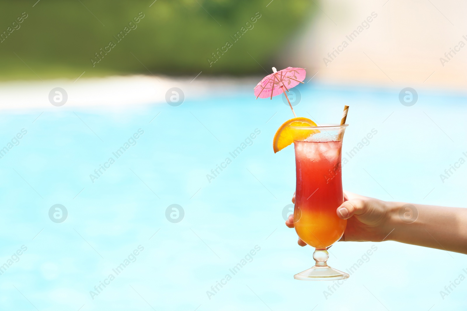 Photo of Woman holding glass with delicious cocktail outdoors