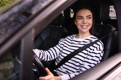 Woman with safety seat belt driving her modern car