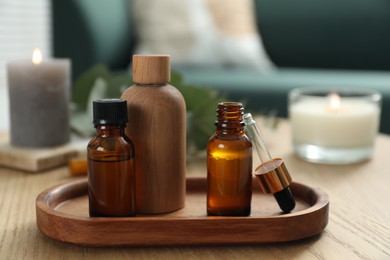 Photo of Aromatherapy. Bottles of essential oil on wooden table