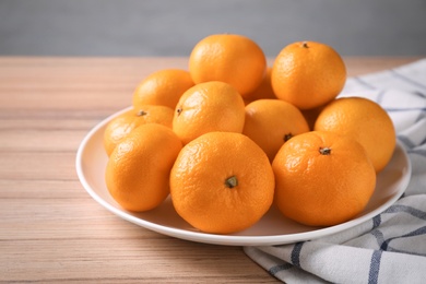 Fresh tangerines on wooden table. Citrus fruit