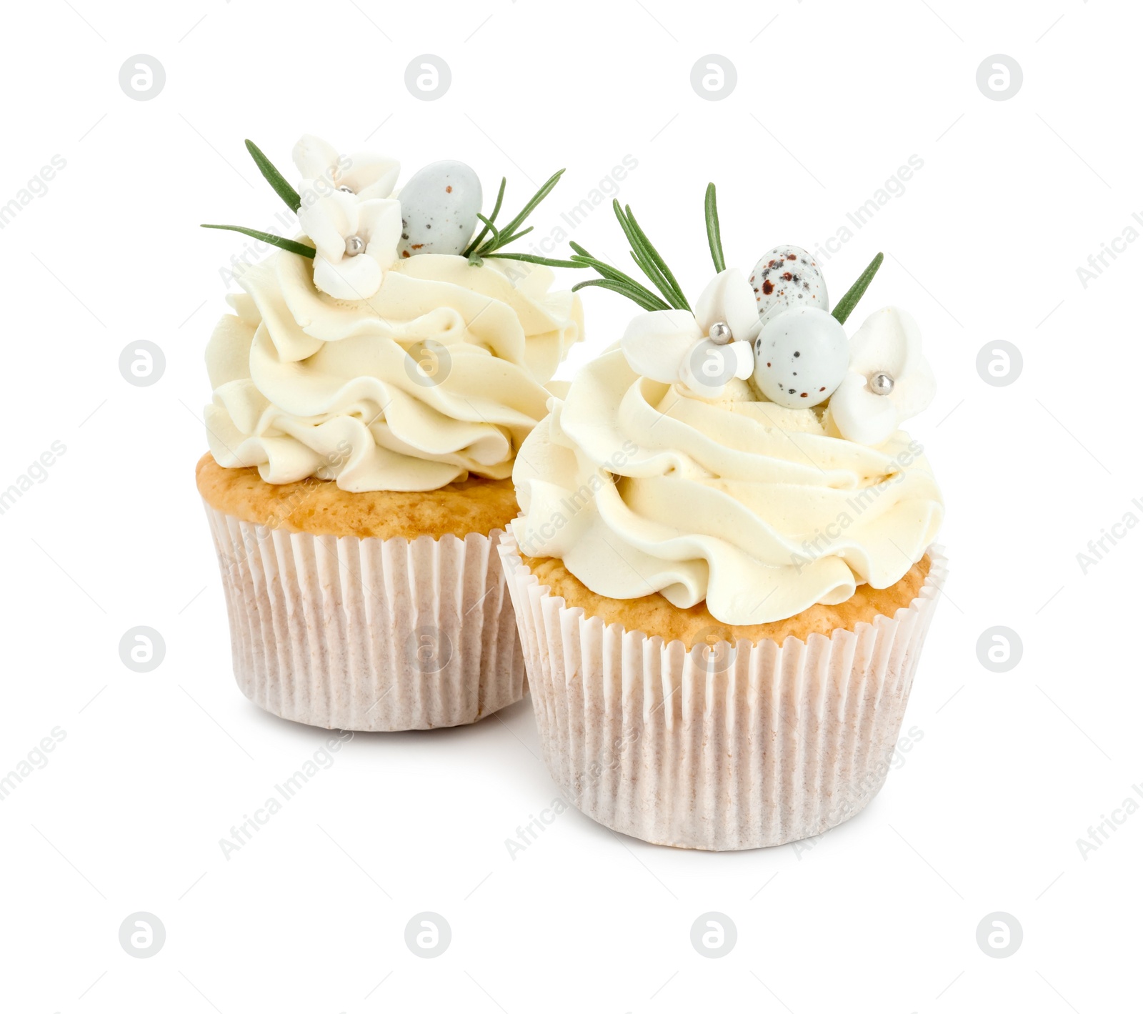 Photo of Tasty Easter cupcakes with vanilla cream isolated on white