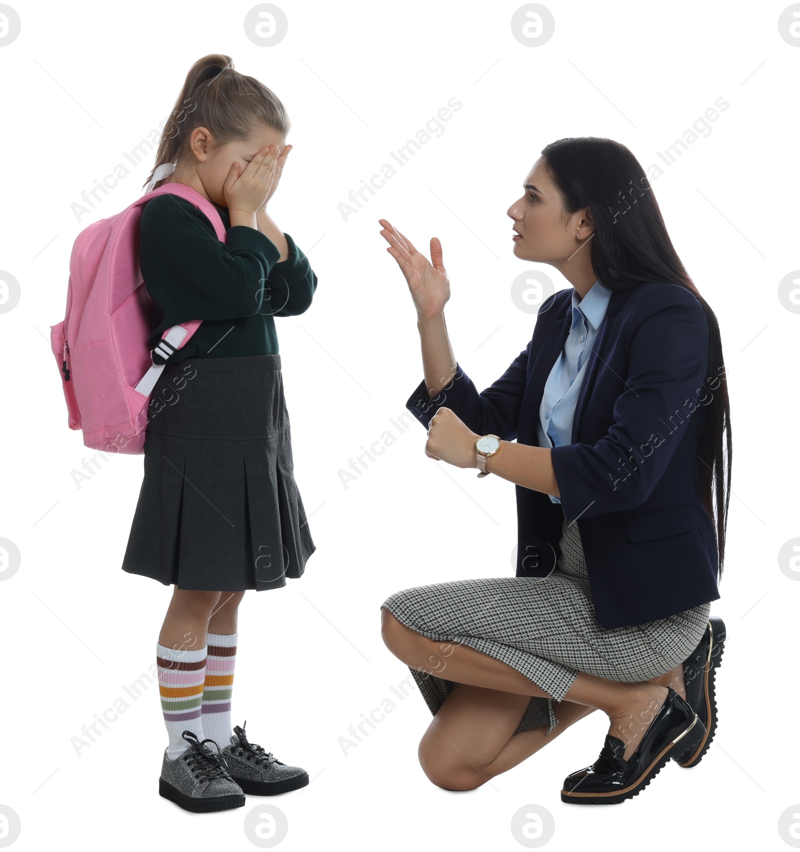 Photo of Teacher pointing on wrist watch while scolding pupil for being late against white background