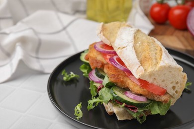 Delicious sandwich with schnitzel on white tiled table, closeup. Space for text