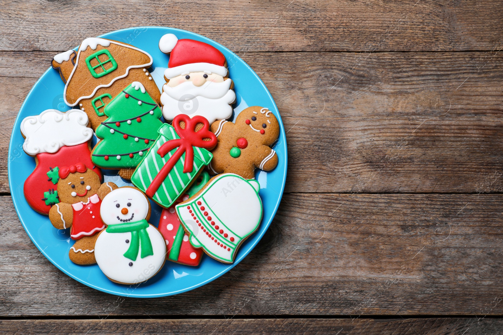 Photo of Delicious Christmas cookies on wooden table, top view. Space for text