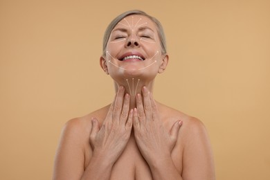 Woman with perfect skin after cosmetic treatment on beige background. Lifting arrows on her neck and face