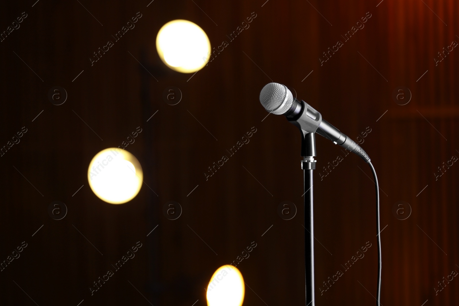 Photo of Microphone against festive lights, space for text