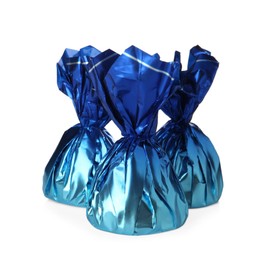 Delicious candies in blue wrappers on white background