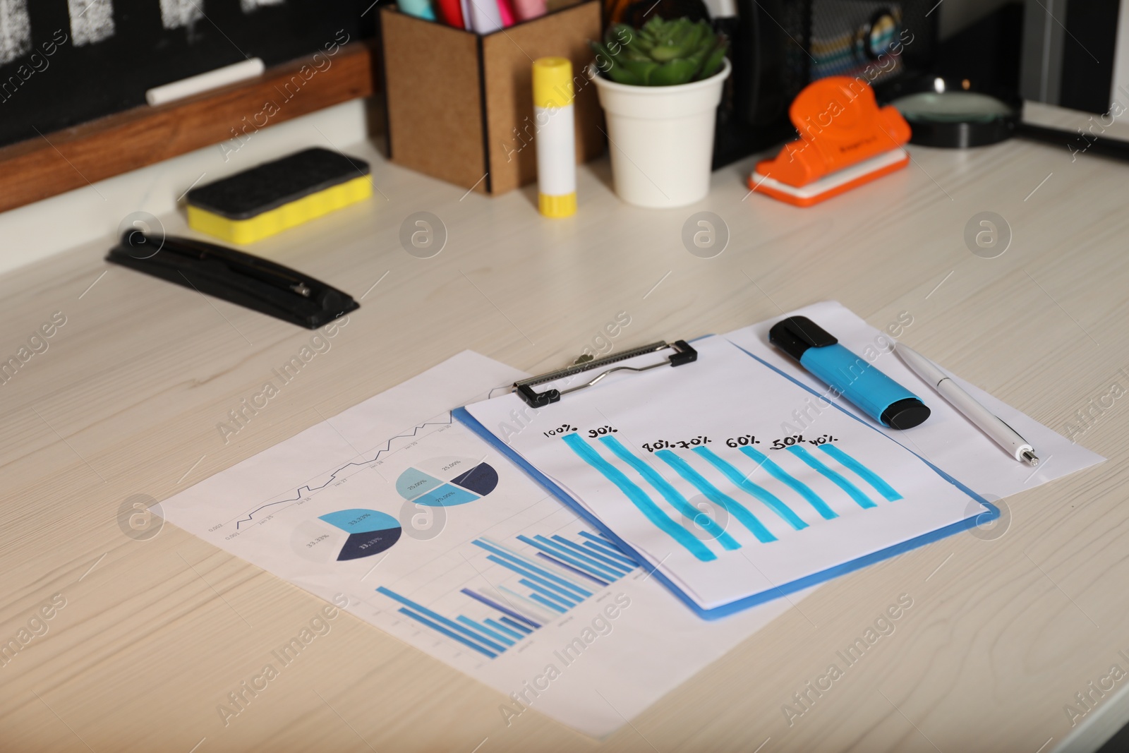 Photo of Business process planning and optimization. Workplace with different graphs and other stationery on wooden table