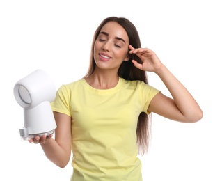 Woman enjoying air flow from portable fan on white background. Summer heat