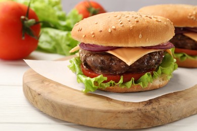 Photo of Tasty hamburgers with patties, cheese and vegetables on white wooden table, closeup
