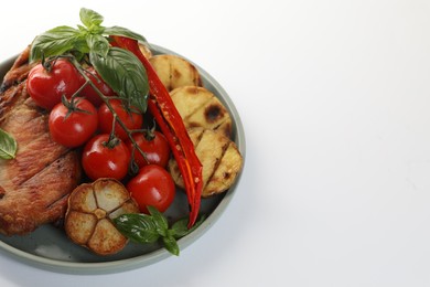 Photo of Plate with tasty grilled vegetables, meat and basil isolated on white