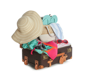 Photo of Open vintage suitcase with different beach objects packed for summer vacation isolated on white