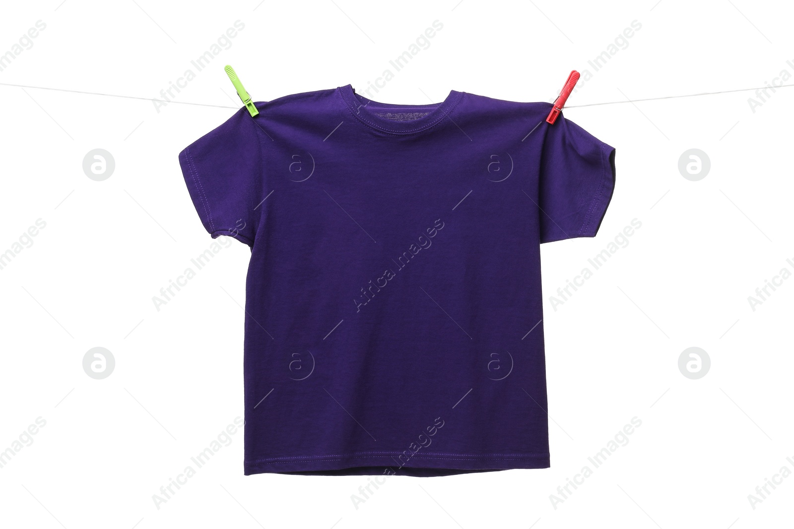 Photo of One purple t-shirt drying on washing line isolated on white