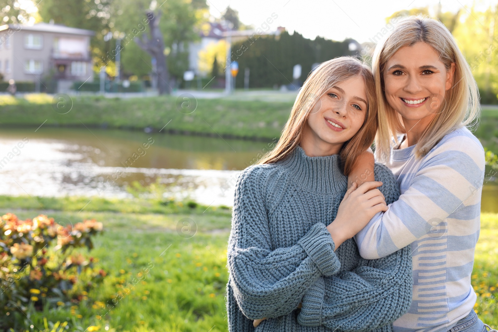 Photo of Happy mother with her daughter spending time together in park on sunny day