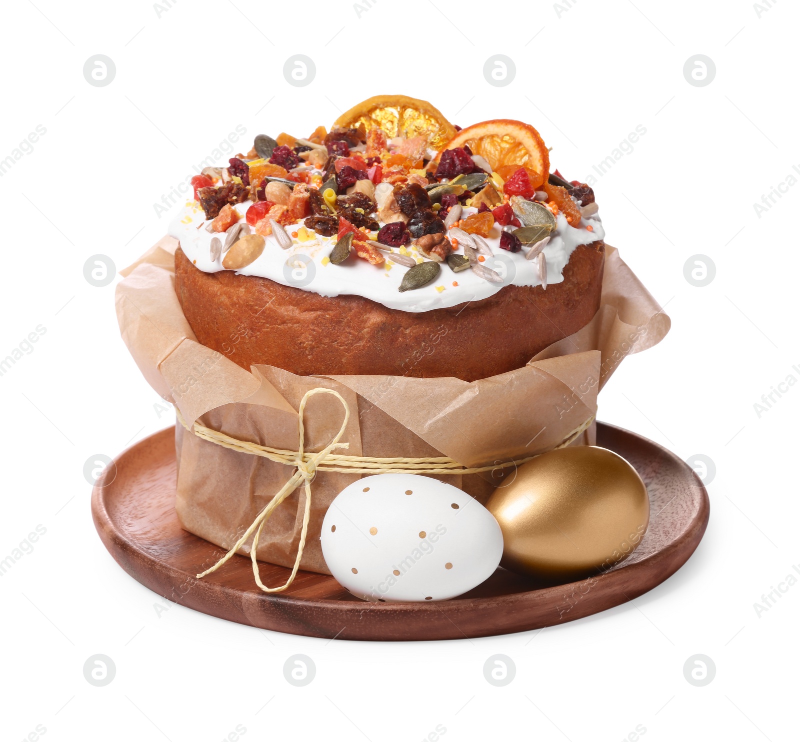 Photo of Traditional Easter cake with dried fruits in parchment paper and painted eggs isolated on white