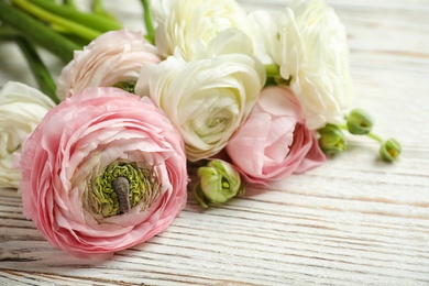 Beautiful ranunculus flowers on wooden background