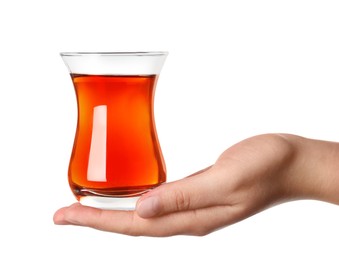 Woman holding glass of traditional Turkish tea on white background, closeup