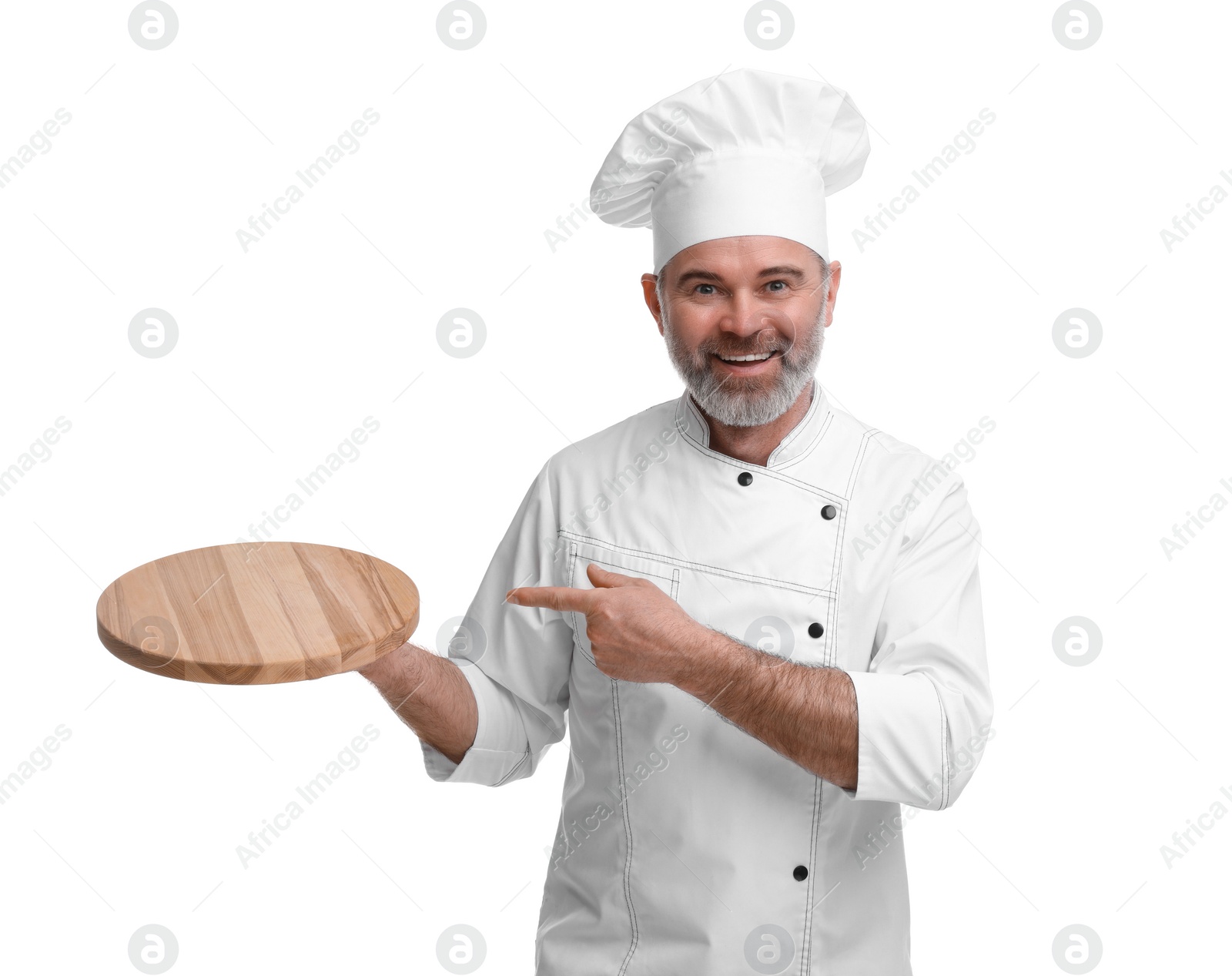 Photo of Happy chef in uniform pointing at wooden board on white background