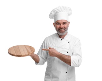 Photo of Happy chef in uniform pointing at wooden board on white background