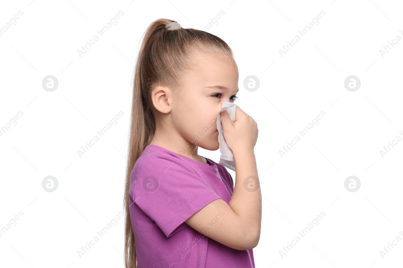 Photo of Sick girl blowing nose in tissue on white background. Cold symptoms