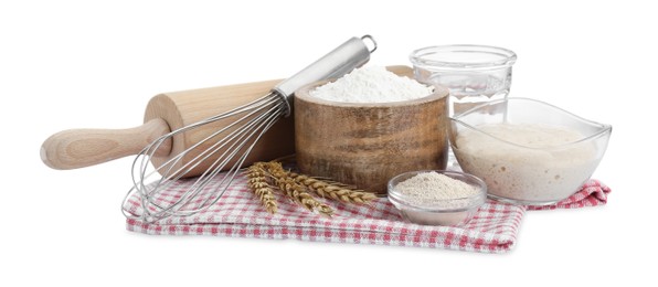 Photo of Leaven, flour, water, rolling pin, whisk and ears of wheat isolated on white