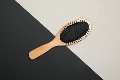 Photo of Modern hair brush on color background, top view