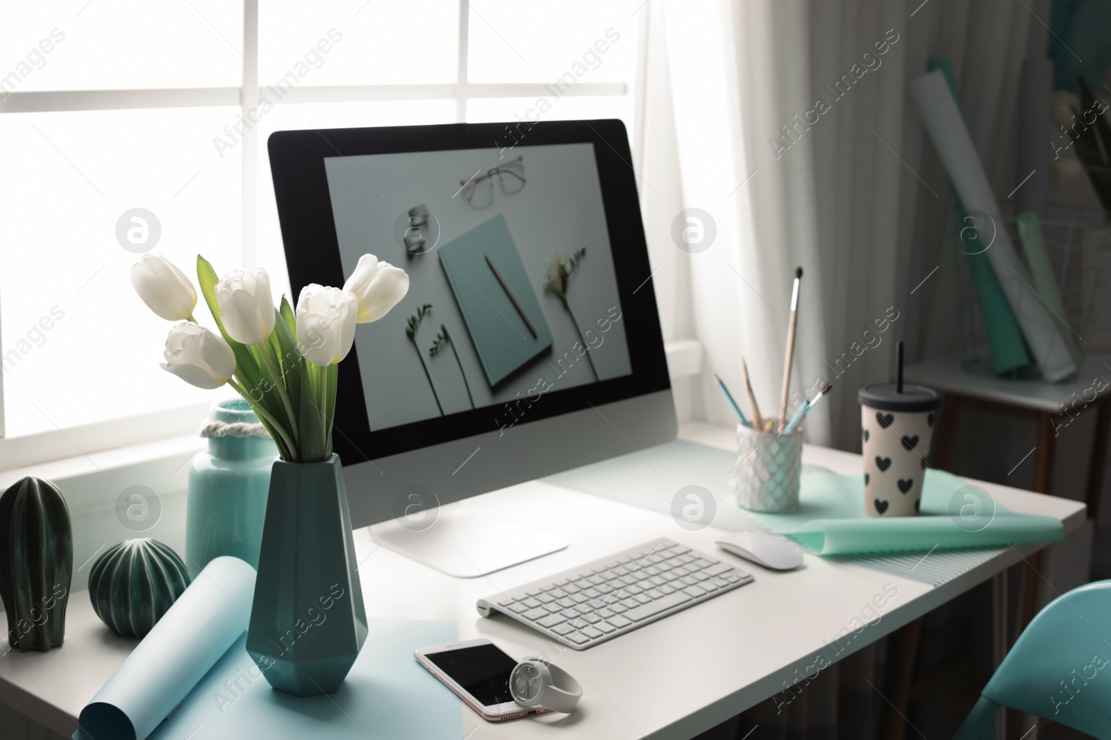 Photo of Stylish workplace interior with modern computer on desk