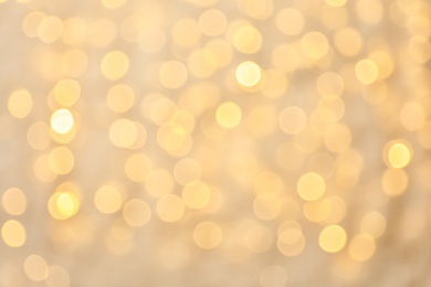 Photo of Blurred view of golden Christmas lights as background. Bokeh effect