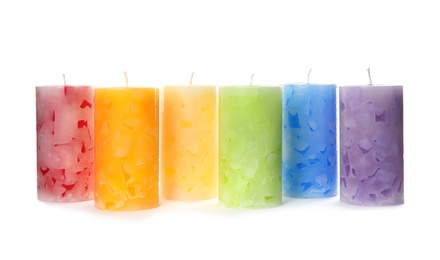 Six color wax candles on white background