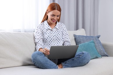 Woman having video chat via laptop at home